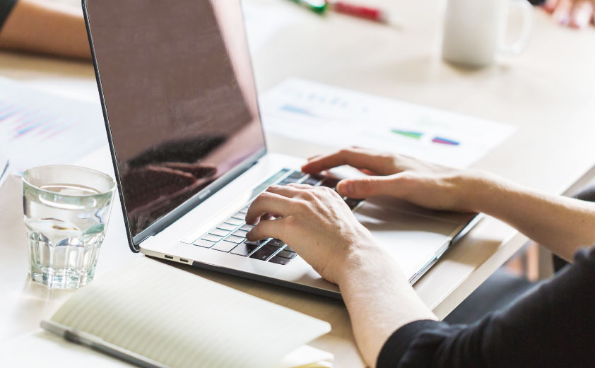 A person typing on a laptop