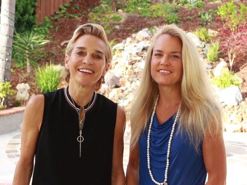 two smiling women with blonde hair