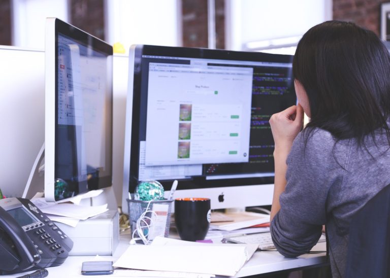 Woman looking at a desktop computer